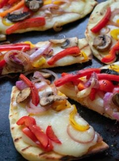 Grilled flatbread pizza recipe that's a tasty summertime treat. Easy to make with naan bread, toppings and creamy fresh mozzarella cheese. | joeshealthymeals.com
