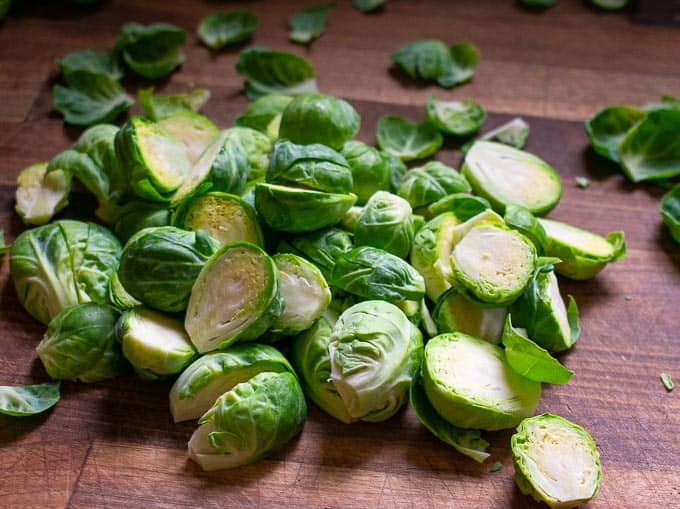 Raw sprouts, halved and ready to roast.