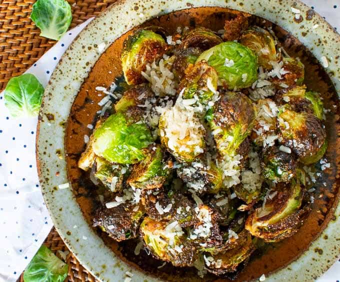 Parmesan roasted Brussels sprouts in a bowl. Caramelized and tender.