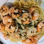 Shrimp scampi on top of spaghetti.