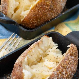 Baked potatoes with garlic salt and oregano seasoned skins.