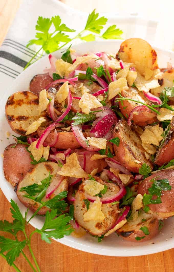 Grilled baby red potatoes with pickled red onions in a bowl ready to serve. #potato salad #grilling #picnic food #side dish