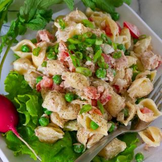 Classic cold tuna salad with onions, celery, tomatoes and peas.