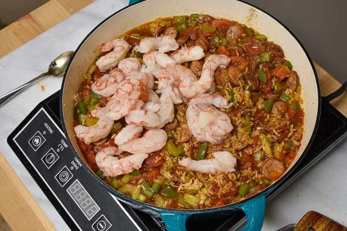 Raw shrimp added to the jambalaya to cook.