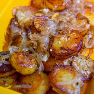 Fried potato and onion recipe in a serving dish.