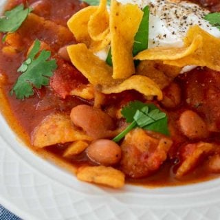 bowl of chili with sour cream and Fritos