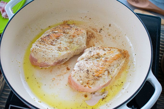 Browning chicken breasts in a hot skillet.