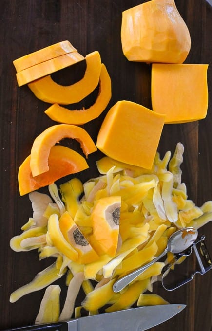 Butternut squash being peeled and sliced.