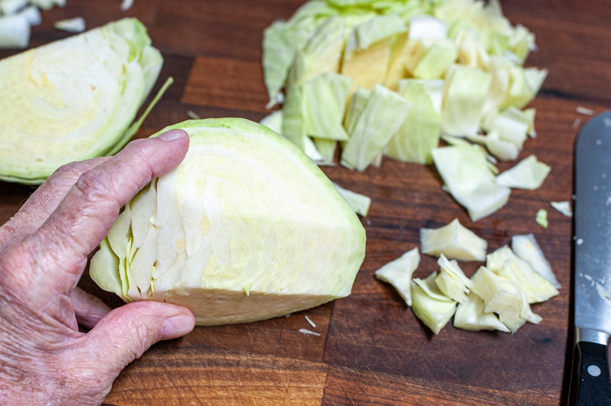 Wedge of cabbage being cut up.