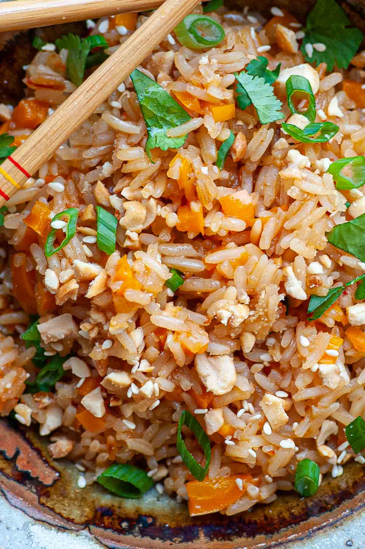 Close-up of cooked rice with chopped cilantro, and green onions.