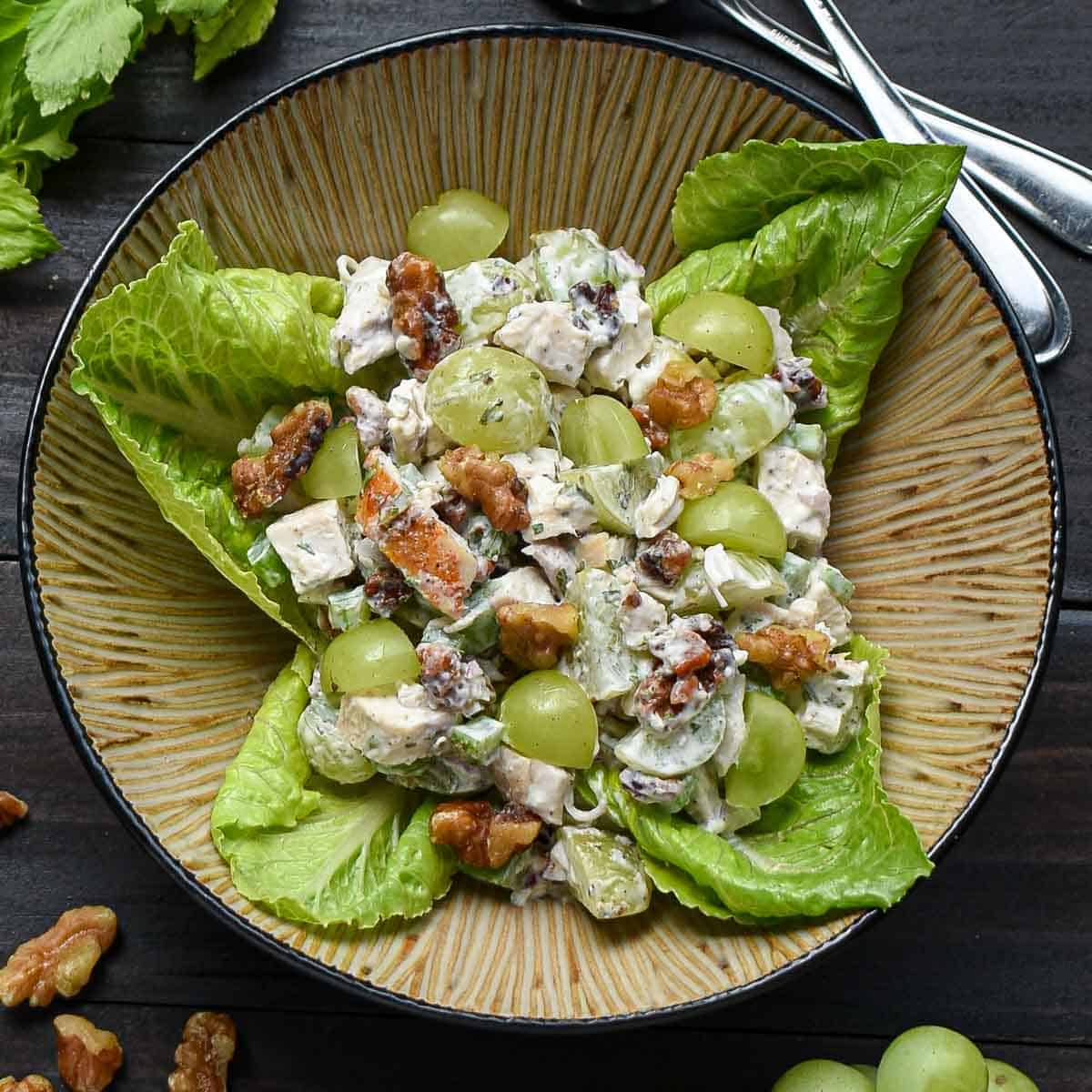 Rotisserie chicken salad recipe with grapes and walnuts in a bowl.