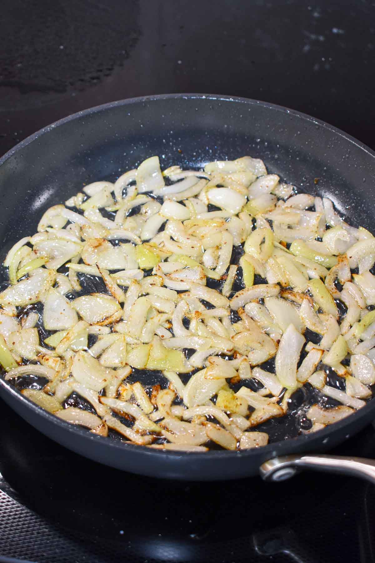 Onions cooking in a skillet.