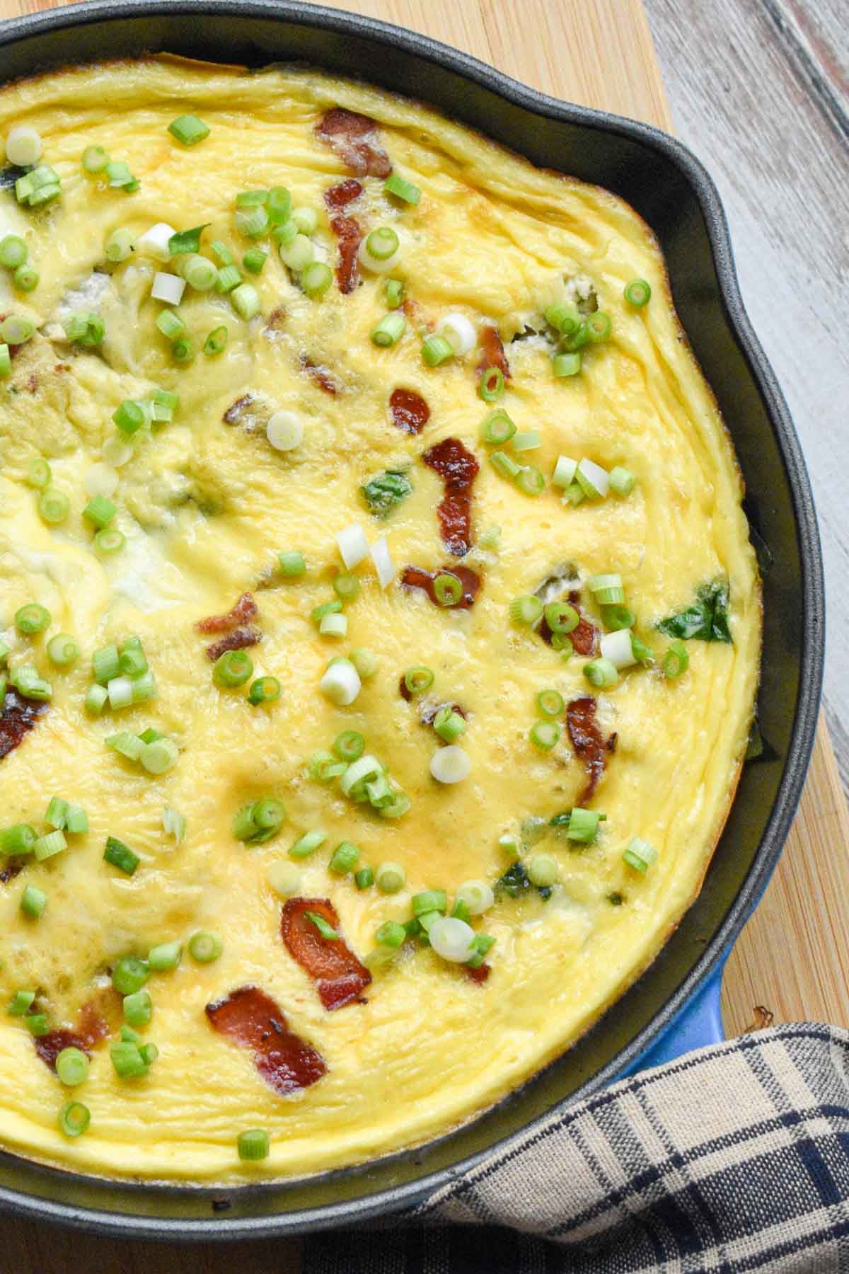 Cooked bacon, cheese frittata resting before serving.
