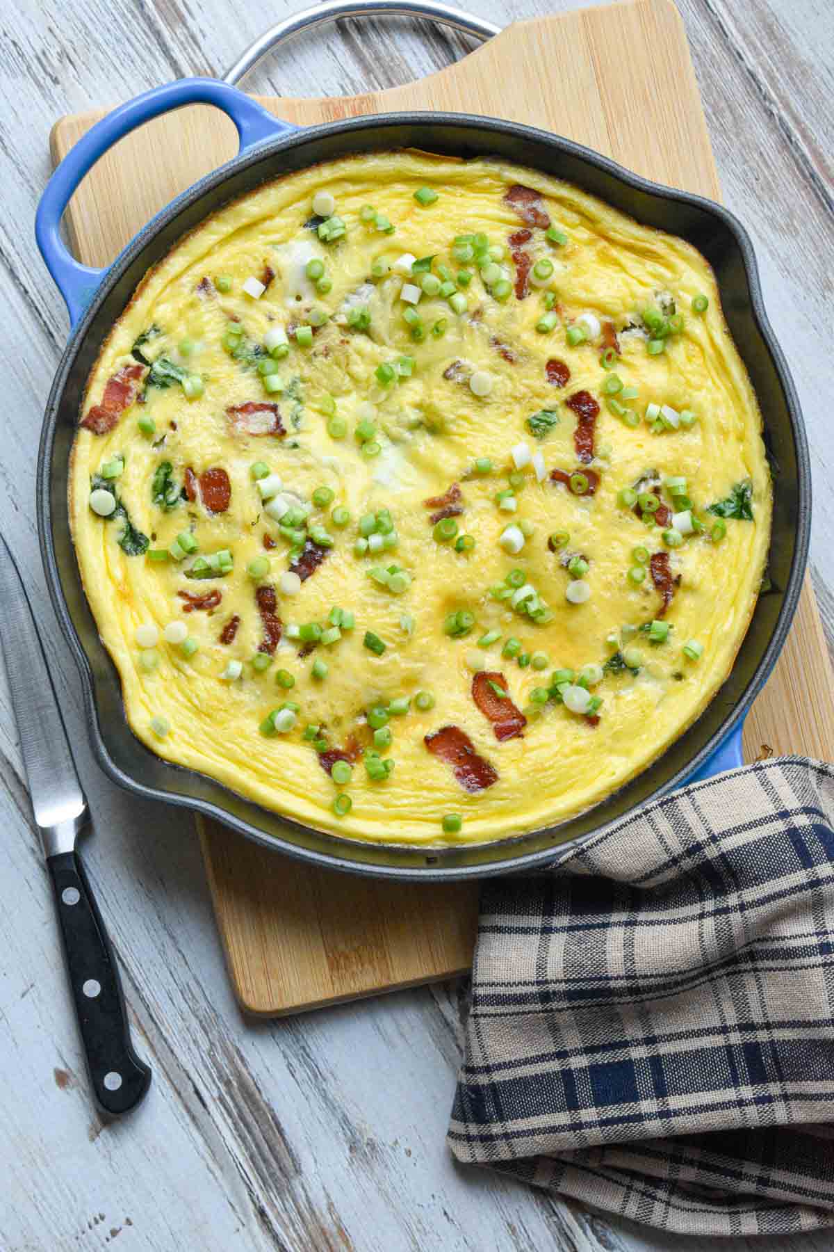 Bacon and cheese frittata in a cast iron skillet.